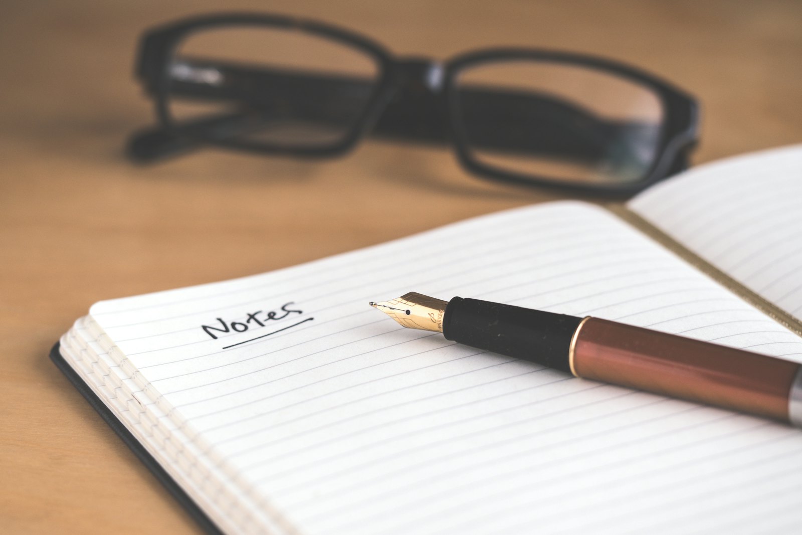 An open notebook with handwritten retirement income planning notes beside a cup of tea